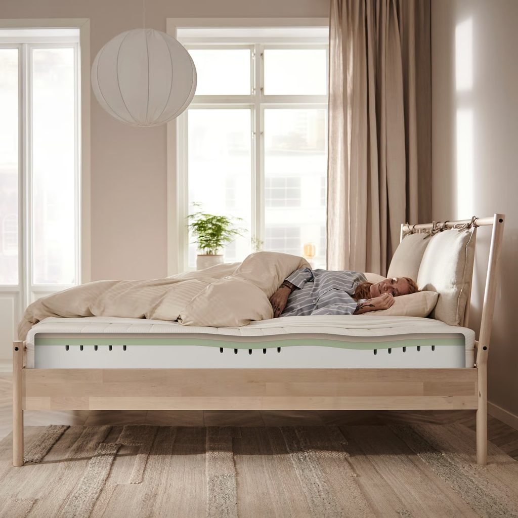 IKEA Åkrehamn op een houten bed met slapende vrouw