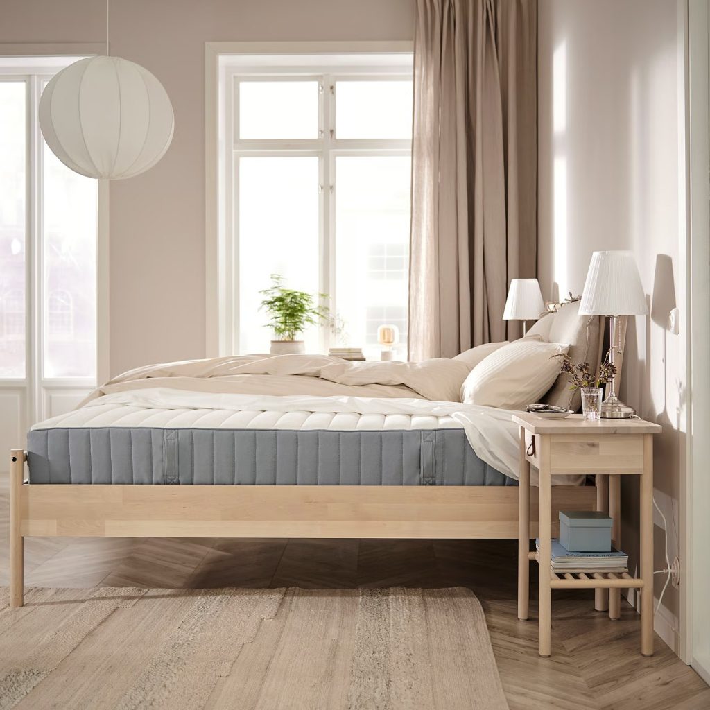 IKEA Valevåg op een houten bed in een lichte slaapkamer